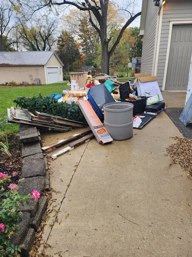 Dumpster being loaded with debris for 10 Yard Dumpster Rental in Alsip